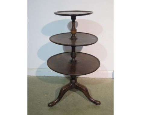 A 19th Century three tier mahogany circular dumb waiter on a tripod base, 122cm tall, 69cm diameter, tapering to 45cm diamete