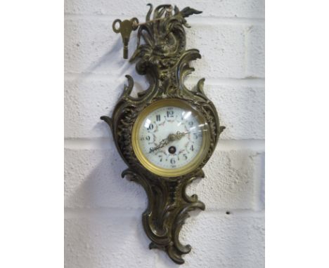A 19th century cartel clock, brass case, with Arabic dial, convex glass approx 29cm long, with key and working condition 
