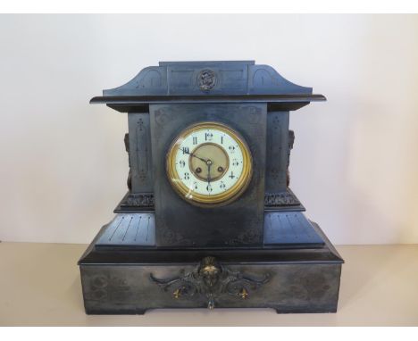 A large Victorian black marble mantle clock, 45cm tall, 48cm wide, some small chips, ticks but stops 