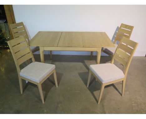 An Ercol oak Romana range dining table in clear matt finish with four chairs, purchased recently from Furniture Village for £