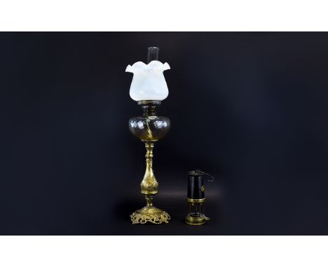 Antique Brass Oil Lamp And Miners Lamp An impressive brass based oil lamp with scroll design to feet and base, outer shade in