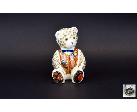 A Royal Crown Derby Paperweight In The Form Of A Teddy Bear Seated bear figure in white ceramic with highly decorated waistco