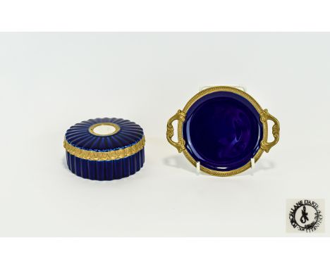 Two Decorative Ceramic Items By John Jenkins A small cobalt blue ceramic trinket box with gilt trim and central neoclassical 