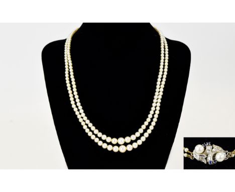 A Nice Quality Double Strand Cultured Pearl Necklace, with 18ct Gold Set Diamond and Sapphire Clasp, From The 1950's. Fully H