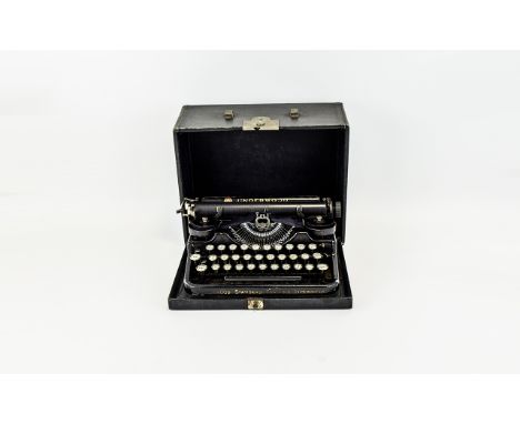 A Vintage Underwood Portable Typewriter Cased typewriter in traditional black lacquer finish with circular Qwerty keys. Good 