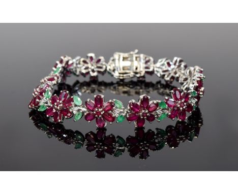 Ruby and Emerald Flower Line Bracelet, each flower comprising six oval cut rubies around a central round cut, with two marqui