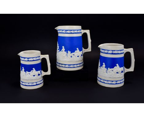 Set of Three Copeland Spode Graduated Blue and Cream Stoneware Jugs, each showing a panoramic hunting scene in relief, with l