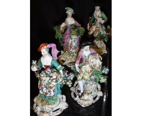 A set of four figures in the manner of Derby, emblematic of the four seasons, each raised upon pierced scrolling Rococo bases