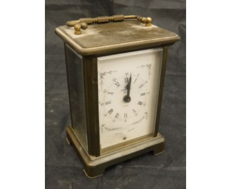 A brass cased carriage clock, the eight day movement by Ouverdrey et Bloquel, the face with Roman and Arabic numerals inscrib