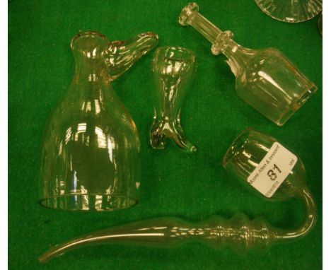 A 19th Century facet cut glass toddy lifter of mallet form, together with a plain glass stirrup cup of boot form, another sma