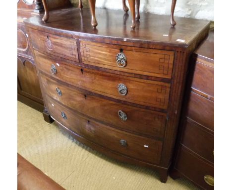A Regency mahogany bow fronted chest with two short over three long graduated drawers with brass ring handles raised on brack