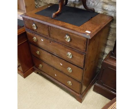 A 19th Century North Country English oak and cross banded chest of two short over three long graduated drawers on bracket fee