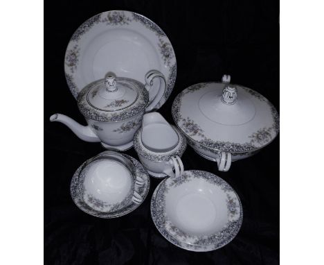 A Noritake part dinner and tea service decorated with floral sprays on a cream ground to consist of teapot, six cups, saucers