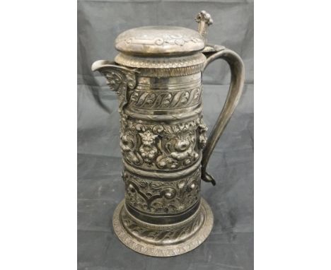 A 19th Century silver plated lidded ewer with embossed floral lion mask and fruit decoration of cylindrical form to a flared 