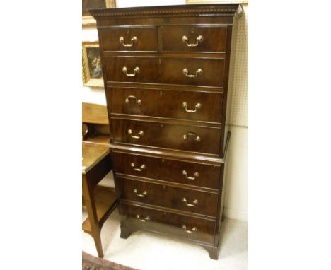 A 20th Century mahogany chest on chest of small proportions in the George III taste, the upper section with two short over th