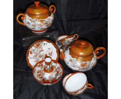 A Japanese satsuma ware part tea wares to include two teapots, twelve teacups and saucers,  a stem vase and a bowl, together 