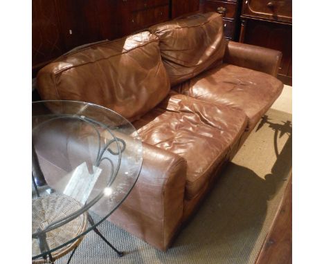 A brown leather upholstered sofa, a matching smaller sofa and pouffe/stool CONDITION REPORTS Big sofa with stain mark to seat