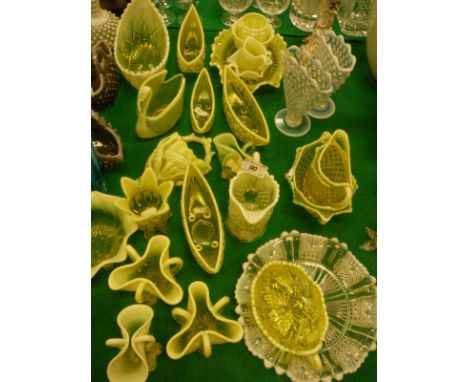 A collection of Fentons Uranium glass ware in yellow, white and brown to include boat-shaped bowls, swan-shaped bowl, plates,