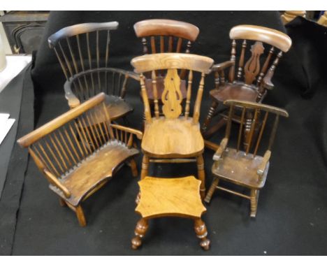 Seven miniature chairs, benches and stools to include miniature shaped top stool on turned supports, an oak pierced vase back