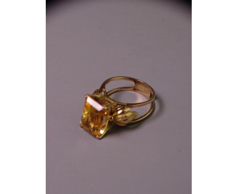 14CT GOLD CITRINE DRESS RING with emerald cut faceted citrine, approximately 12.5 x 8.7mms and the ring having leaf decorated