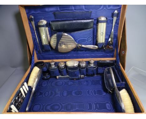 LADIES FITTED TRAVEL/VANITY CASE with protective cover, 24 pieces including silver topped bottles, hand mirror, brushes, shoe