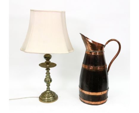 A large copper bound coopered oak pitcher, 62cm high and a brass altar candlestick style table lamp, in 17th century style, 6