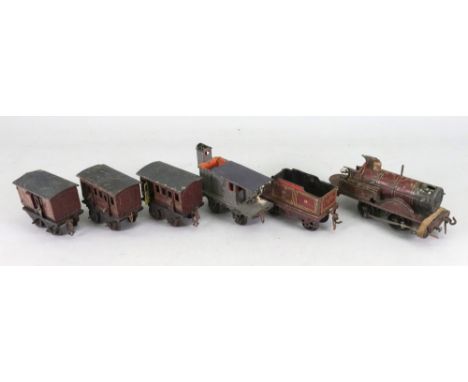 A vintage German M.R. 2031 litographed tinplate 'O' gauge tank engine and fender, three carriages and crane bogey (6).