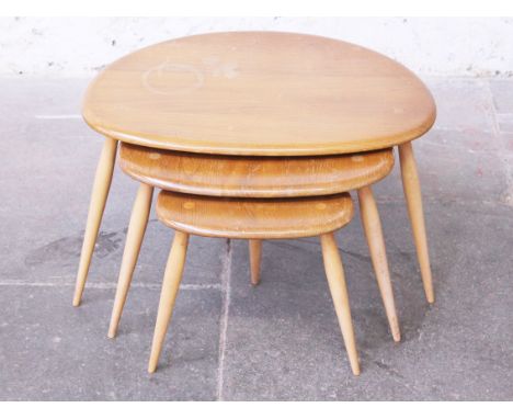 A nest of three Ercol light elm and beech "pebble" tables. Condition - general wear to all surfaces to include marks and scra