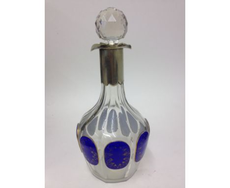 A bohemian facetted glass decanter with gilt blue panels. H28.5cm. Condition - general wear to include scratches , wear to gi