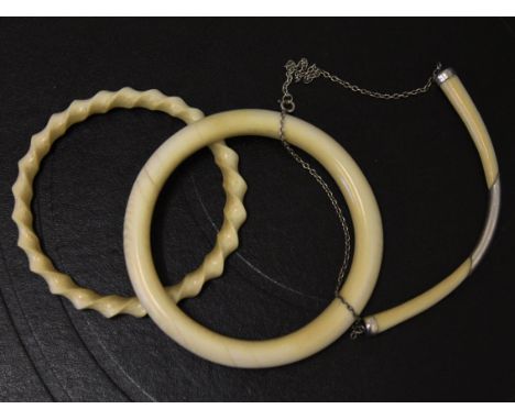 Two ivory bangles and a silver mounted ivory necklace, early 20th Century. Condition - one ivory bangle broken, general wear 