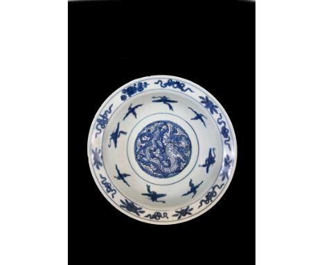 Painted to the centre with a winged aquatic dragon, the underside with a four-character mark chang ming fu gui   Diameter: 35