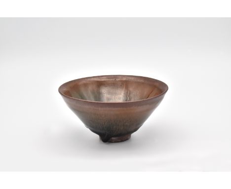 The conical bowl covered in a running russet and black glaze falling short of the foot, exposing the unglazed purplish-brown 