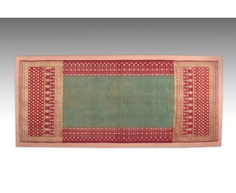 With a rectangular green field and crimson and gilt border, mounted on a stretcherDimensions: 214cm by 95cm overallProvenance