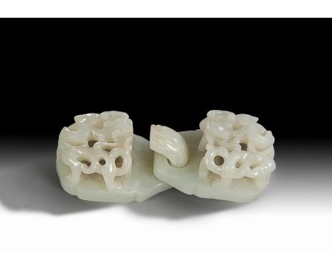 Each interlocking piece deeply carved with a sinuous chilong dragon (2)   Length: 11cm   Provenance: The Canterbury Auction G