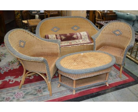 A wickerwork five piece conservatory suite comprising, two seat sofa, two armchairs, obround coffee table with undertier and 