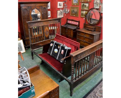An oak four piece  bedroom suite comprising  double wardrobe, outswept cornice, shaped mirrored central door flanked by panel