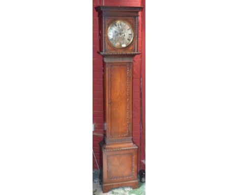 An oak longcase clock, stepped cornice, dot and dash beading, silvered circular dial, Roman numerals, gadrooned border to bas