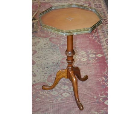 A reproduction leather inlaid, galleried octagonal topped occasional tripod table, turned column purchased at Bennets of Derb