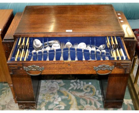 An Art Deco oak cutlery canteen table, including EPNS cutlery 