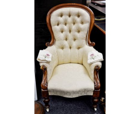 A Victorian mahogany spoon back armchair, button upholstered back, outswept arms, serpentine stuffed overseat, turned foreleg
