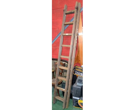 A vintage wooden extension ladder.
