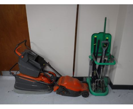 Two Flymo electric lawnmowers, together with a plastic bin stand, a bundle of garden tools and a set of aluminium folding ste
