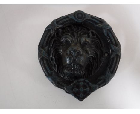 A cast metal lions head door knocker