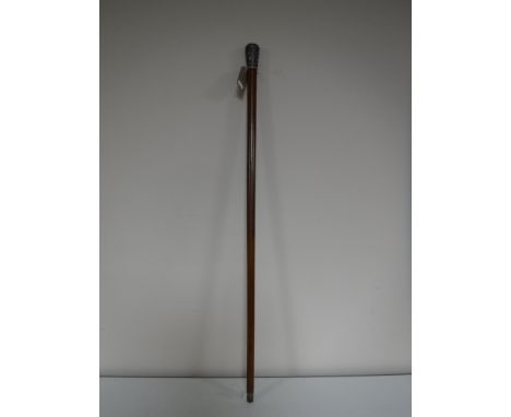 A walking stick with an Eastern white metal pommel 