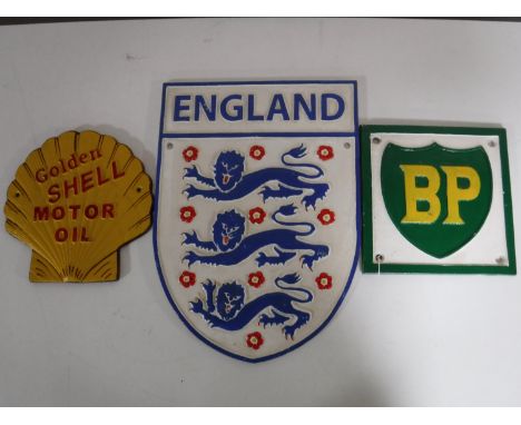 Three cast metal advertising signs, including an England crest, BP and Shell 