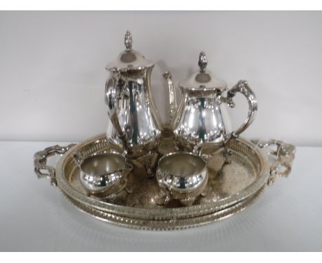 A four piece plated tea service, together with two twin handled gallery trays 