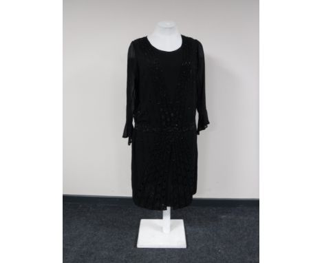 A 1920's hand beaded flapper dress on vintage mannequin 