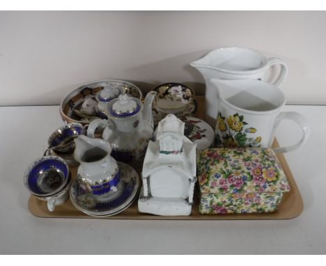 A tray containing children's tea service, miniature German tea service, two Portmeirion jugs, a Royal Winton chintz lidded mu