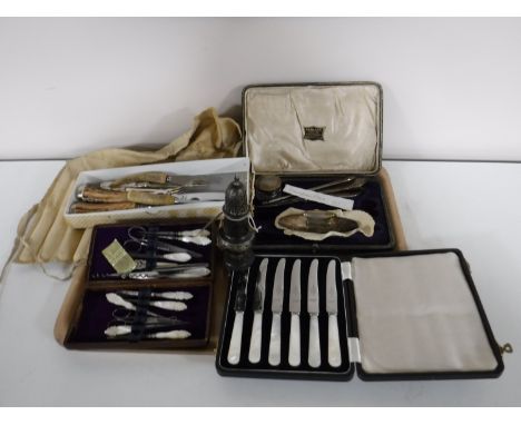 A tray containing sterling silver sugar sifter, a part mid twentieth century sterling silver manicure set (Birmingham, 1946),
