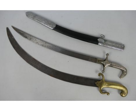 A Middle Eastern scimitar type sword, the white metal mounted scabbard decorated with hunting scene and script, 61 cm (l) and